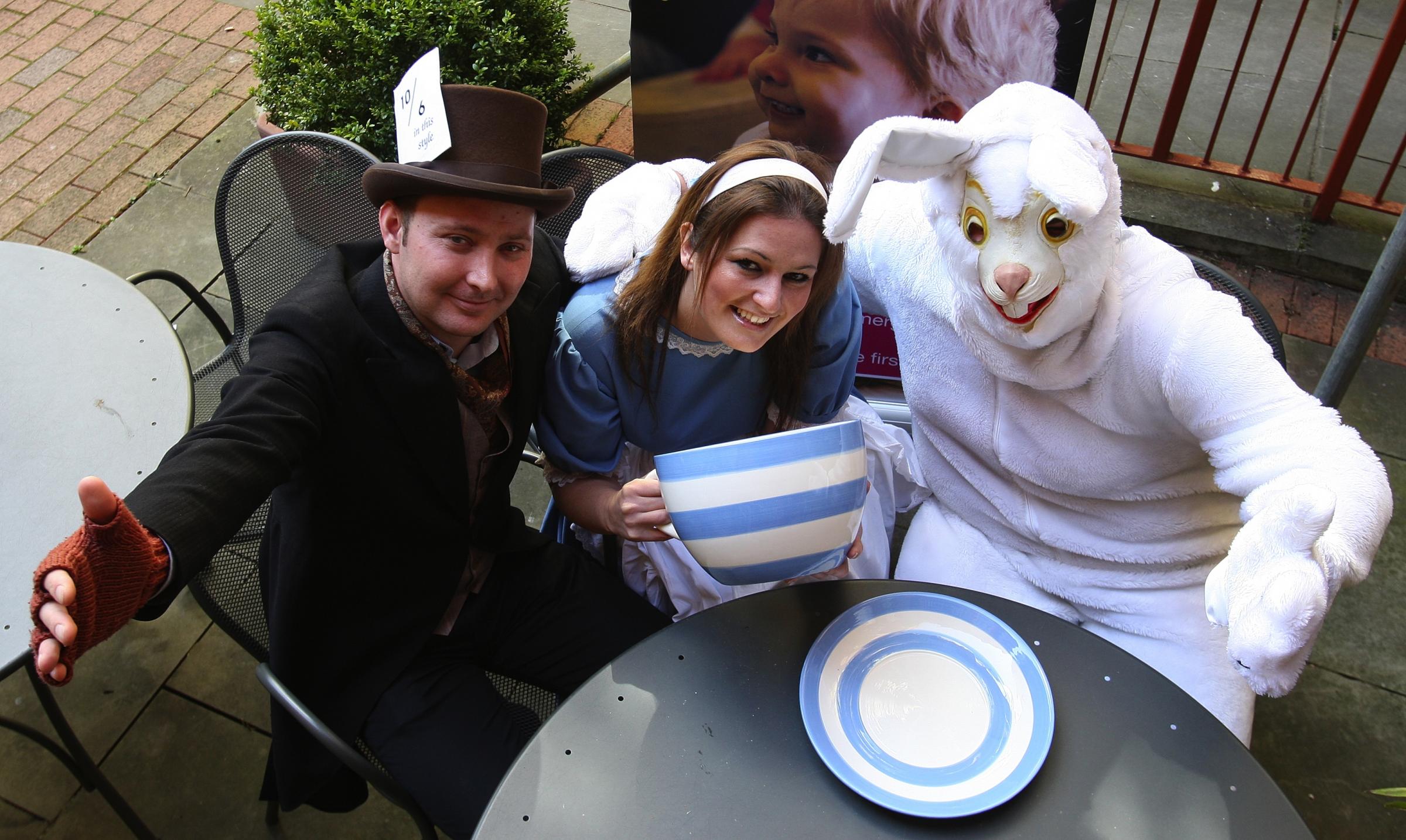 Winchester Guildhall Courtyard Cafe team Mad Hatters Tea Party: Alice alias Hannah Scott with White Rabbit better known as Sam Earley and The Mad Hatter himself Gary Fisher.